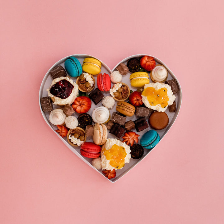 Dessert-filled heart on a pink background