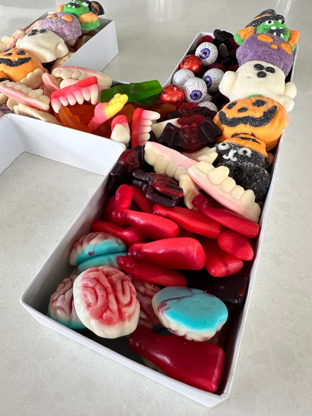 Close-up of Halloween lollies in a letter H gift box